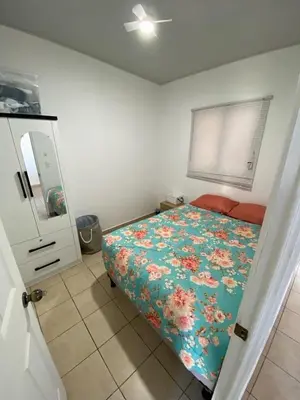 a bedroom with a bed with a floral comforter at Ecoterra villas del sol in Comecayo