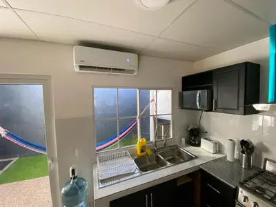 a small kitchen with a sink and a window at Ecoterra villas del sol in Comecayo