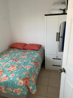 a bedroom with a bed and a white cabinet at Ecoterra villas del sol in Comecayo