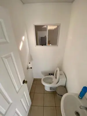 a small bathroom with a toilet and a sink at Ecoterra villas del sol in Comecayo