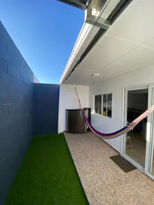 a room with a hammock on the side of a building at Ecoterra villas del sol in Comecayo