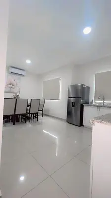 a kitchen with a table and chairs and a refrigerator at Stylish house close to tourist attractions in La Libertad