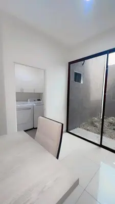 a white room with a table and a window at Stylish house close to tourist attractions in La Libertad
