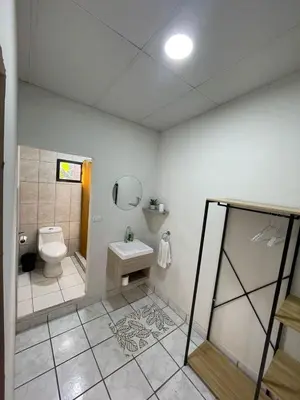 a bathroom with a toilet and a sink at Apaneca House in Apaneca
