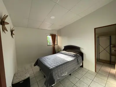 a bedroom with a bed in a room at Apaneca House in Apaneca