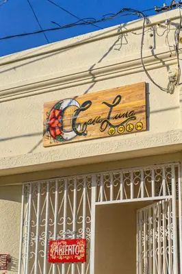a sign for a candy store on the side of a building at Hostal CASA LUNA in Santa Ana