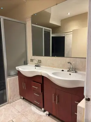 a bathroom with two sinks and a large mirror at Hostal CASA LUNA in Santa Ana