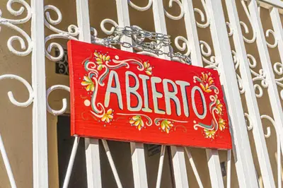 a sign is hanging on a metal fence at Hostal CASA LUNA in Santa Ana