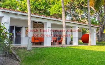 a house with a sign that reads check last volunteer estates for direct request at Casa Las Doroteo in El Sunzal