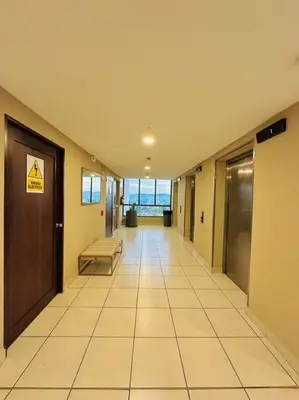 an empty hallway with a bench and a door at Tower View 360º in San Salvador