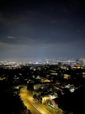 a view of a city at night with lights at Tower View 360º in San Salvador
