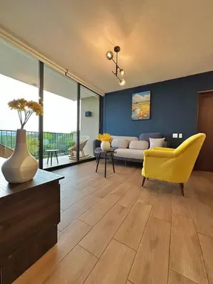 a living room with a yellow chair and a couch at Tower View 360º in San Salvador