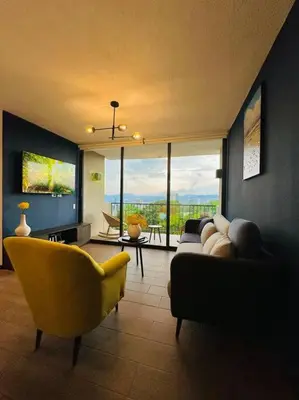 a living room with a couch and a yellow chair at Tower View 360º in San Salvador