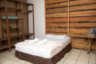 a bedroom with a bed with two towels on it at Las Cabañitas in San Salvador