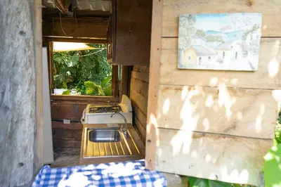 an outside view of a house with a table and a stove at Las Cabañitas in San Salvador