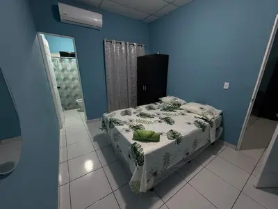 a bedroom with a bed in a blue room at Casa en Nueva Metropolis con aire en toda la casa in San Miguel