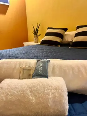 a room with a bed with towels on it at La Casita in Santa Ana
