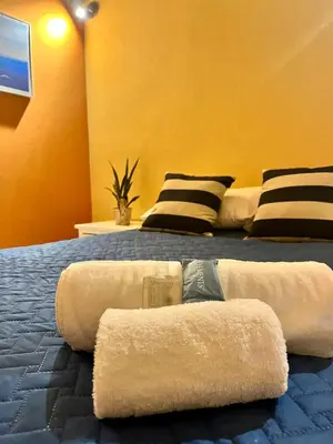 a bedroom with two beds with towels on them at La Casita in Santa Ana