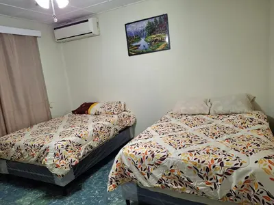 a bedroom with two beds and a picture on the wall at Hostal primaveras nest centro santa ana hab2 in Santa Ana