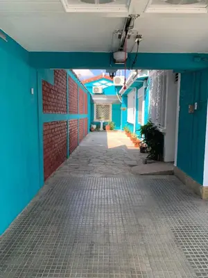 an empty hallway of a building with blue walls at Hostal primaveras nest centro santa ana hab2 in Santa Ana
