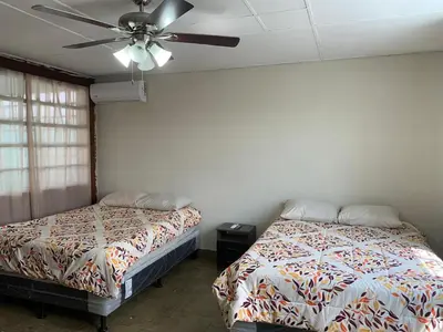 a bedroom with two beds and a ceiling fan at Hostal primaveras nest centro santa ana hab2 in Santa Ana
