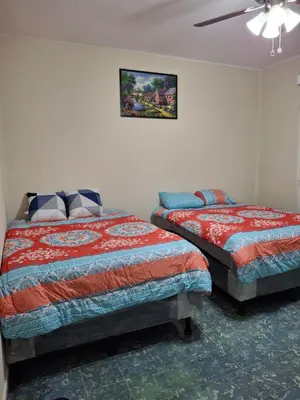a bedroom with two beds and a ceiling fan at Hostal primaveras nest centro santa ana hab2 in Santa Ana