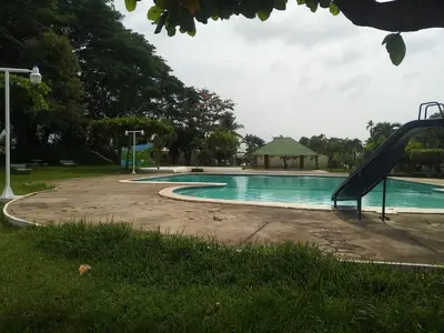 a swimming pool with a slide in a park at bonita casa pequeña in Santa Ana