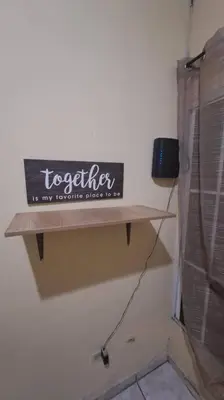 a sign on a wall in a room at bonita casa pequeña in Santa Ana