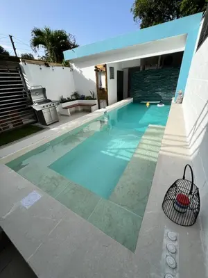 a swimming pool in the backyard of a house at Villas de Carolina in San Salvador