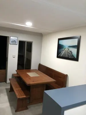 a room with a table and a picture on the wall at Villas de Carolina in San Salvador
