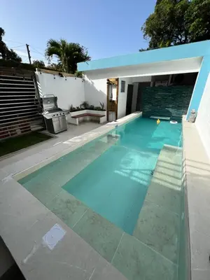 a swimming pool in the backyard of a house at Villas de Carolina in San Salvador