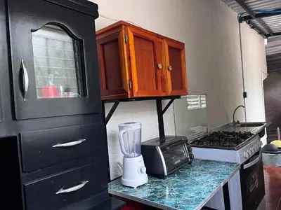 a kitchen with a blender on a counter at Ibania Hostal in Tamanique