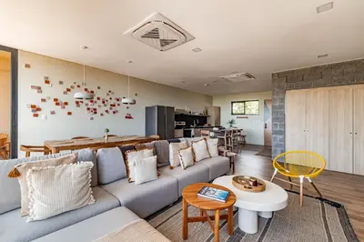a living room with a couch and a table at Wave House in El Zonte