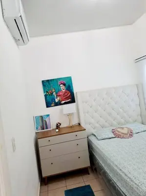 a bedroom with a bed and a dresser with a night stand at casa familiar, HOME sweet HOME san Miguel