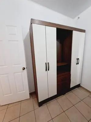 a room with a closet with white cabinets and a door at casa familiar, HOME sweet HOME san Miguel