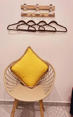 a yellow pillow on a chair in a room at Lofts #9 & #6 Surf EcoVilla Playa El Sunzal in El Sunzal