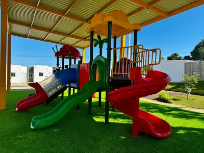a playground with a slide in the grass at Casa Los Ausoles con Jacuzzi in Ahuachapán