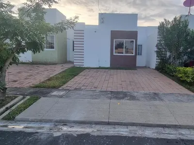 a white house with a brick driveway in front of it at Residencia en Megápolis, San Miguel in San Miguel
