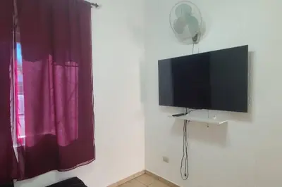 a flat screen tv on a wall next to a window at Residencia en Megápolis, San Miguel in San Miguel
