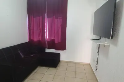 a living room with a couch and a tv at Residencia en Megápolis, San Miguel in San Miguel