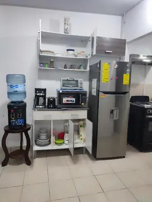 a kitchen with a refrigerator and a table with dishes at KIRAz in Turín