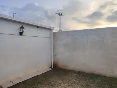 a white garage with a white wall and a lamp at KIRAz in Turín