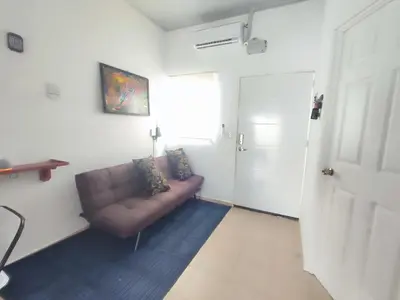 a living room with a brown couch and a door at KIRAz in Turín