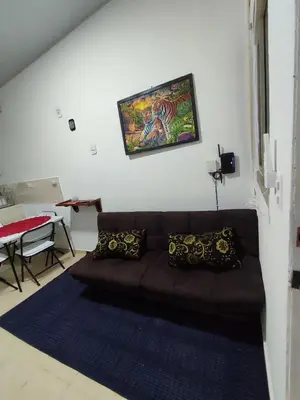a living room with a brown couch and a table at KIRAz in Turín