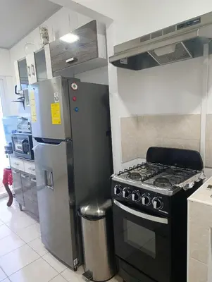 a kitchen with a stove and a refrigerator at KIRAz in Turín