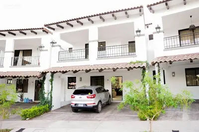 a car parked in front of a building at Beautiful Modern Home in Res San Andres in San Miguel