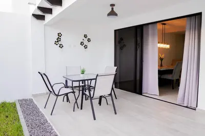 a dining room with a table and chairs at Beautiful Modern Home in Res San Andres in San Miguel