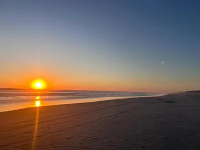 a sunset on a beach with the ocean at Las Brisas Casa frente al mar Costa del Sol in El Zapote