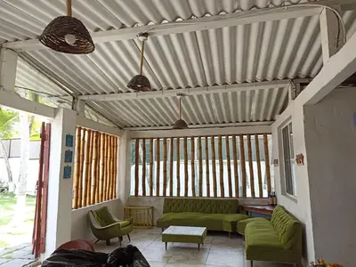 a living room with a couch and a table at Las Brisas Casa frente al mar Costa del Sol in El Zapote