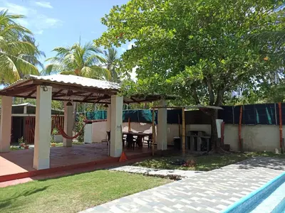 a pergola next to a swimming pool next to a house at Las Brisas Casa frente al mar Costa del Sol in El Zapote
